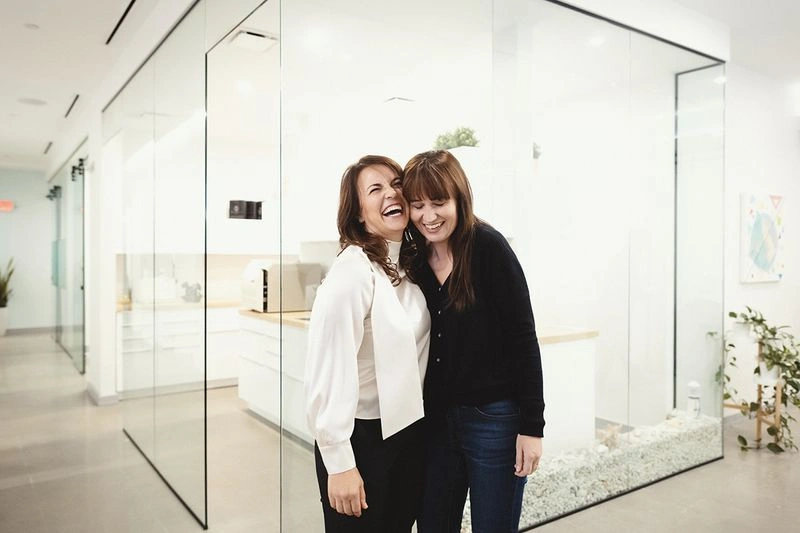 Staff member with Dr. Kaso, both sharing a happy smile