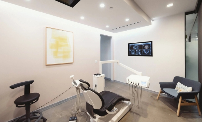 Dental chair with tools and X-ray setup at Dimension Dental in Holmdel