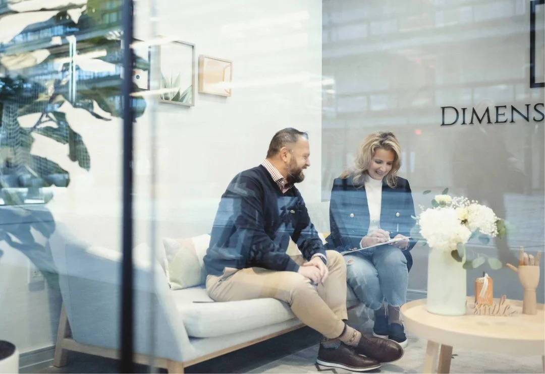 Dentist discussing treatment plan with patient seated in chair