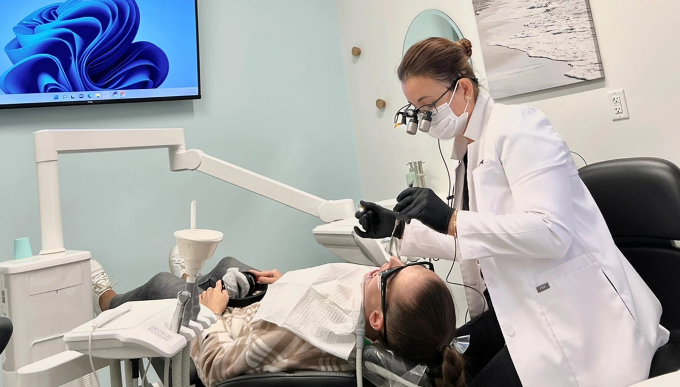 Female patient receiving dental treatment from Dr.Kaso at Dimension Dental office